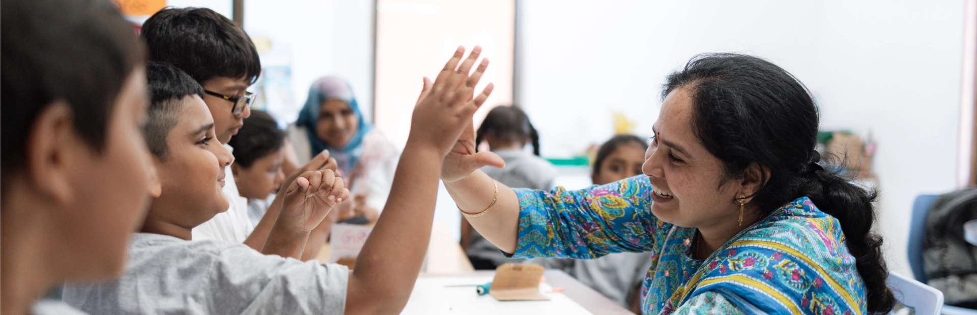 A teacher interacting with students.